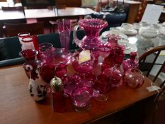 A large collection of cranberry glass