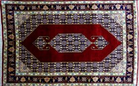 A 20th century fine silk Tabriz rug, with Mahi design on a red and blue ground, 140 x 90cm