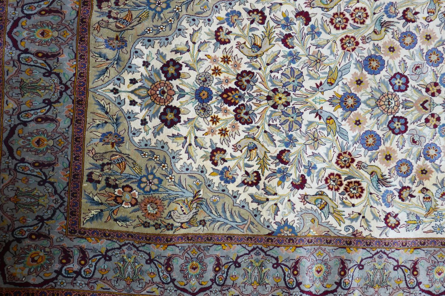 A 20th century fine silk Kashan rug, with zoomorphic and vase of flower design, contained by - Image 2 of 3