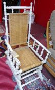 A white painted rocking chair, with rattan backrest and seat, H.110cm