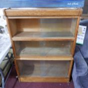 An early 20th century oak sectional bookcase with makers label for Warwick, H.114 W.84 D.28cm