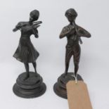 Two cast bronze figures of a young man playing the flute and a young lady playing the violin, on