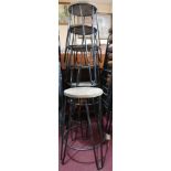 A set of six industrial stools raised on hairpin legs