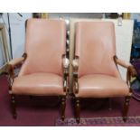 A pair of 19th century mahogany library armchairs, with salmon pink leather upholstery