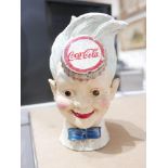 A collection of Coca-Cola memorabilia, to include a cast iron money bank in the form of young boy'