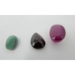 A loose oval cut ruby, together with a loose emerald and a loose tear-drop shaped red stone (3)