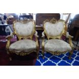 A pair of Rococo style gilt wood armchairs