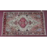 A North West Persian Malayer rug, central diamond medallion with repeating petal motifs on an