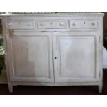 A late 19th century painted French dresser base, with three drawers over two cupboard doors,