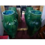 A pair of Persian green glazed Sharab wine vessels, H.92cm (2)