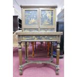 A 1920's Chinoiserie desk, 2 cupboard doors enclosing red lacquered interior, above two drawers,