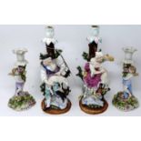 A pair of 18th century Meissen porcelain figural candlestick holders, H.32cm, have been restored,
