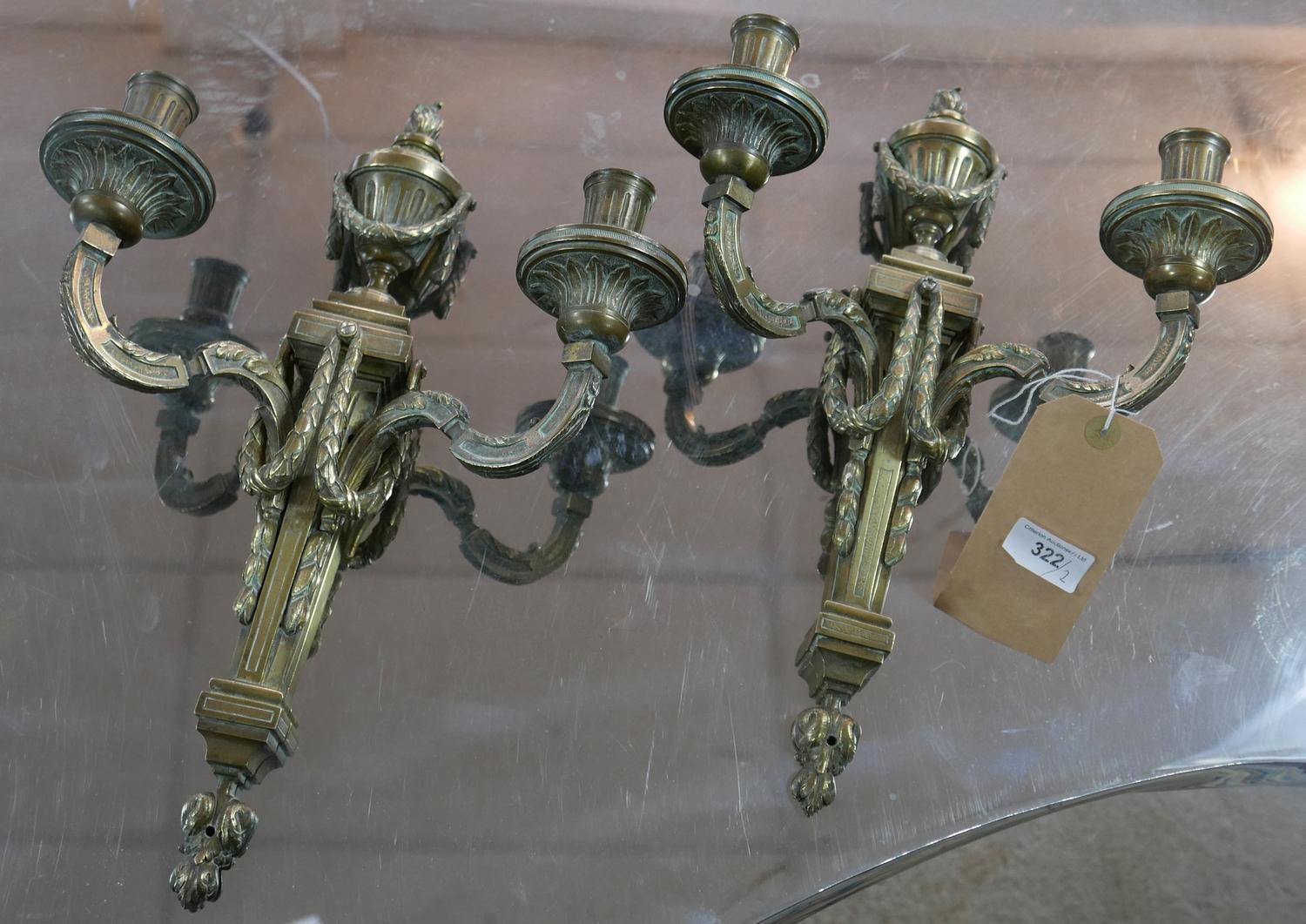 A pair of 19th century ormolu two branch wall sconces, later drilled for wiring, with urn finials