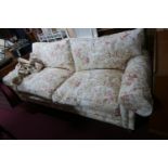 A Zoffany 'Tavistock' range sofa, with floral upholstery, raised on turned legs
