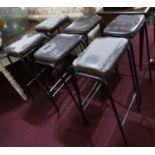 A set of 6 industrial black steel bar stools with brown leather seats