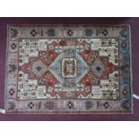 A North West Persian Nahawand rug, central diamond medallion with repeating petal motifs on an ivory