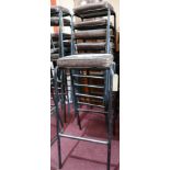 A set of 6 industrial black steel bar stools with brown leather seats