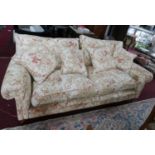 A Zoffany 'Tavistock' range sofa, with floral upholstery, raised on turned legs, small rip to