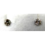 A boxed pair of platinum and brilliant cut diamond stud earrings (0.30 carats total)