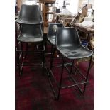 A set of 4 industrial bar stools with leather clad tub seats