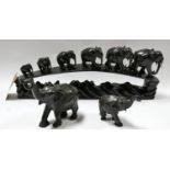 An early 20th century carved ebony group of elephants, together with two others