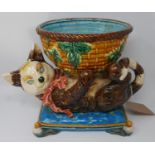 A Minton majolica jardiniere in the form of a cat playing with a ball of string, chip to the foot