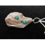 A sterling silver pendant set with two natural rough emeralds, pendant: 4.5 x 3cm, 26g