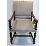 A 19th century oak open elbow chair with brass stud bound upholstery