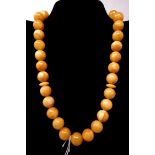 A natural Baltic amber prayer bead necklace with amber tasseled end, L: 65cm, 78g