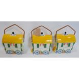 A set of three Old Romany bone china biscuit barrels in the form of caravans, H.30 W.23 D.16cm (3)