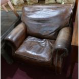 A Howard style brown leather and stud bound armchair