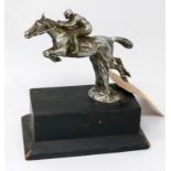 A vintage silver plated car mascot in the form of a jockey on a horse