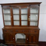 An early 20th century oak dresser, four glazed doors above three drawers and two cupboard doors,