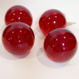 Four red glass bubble paperweights, H.13.5cm (4)