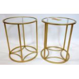 A pair of gilt metal side tables, with circular glass tops, H.46cm Diameter 38cm