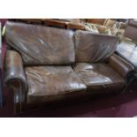 A Howard style brown leather and stud bound sofa