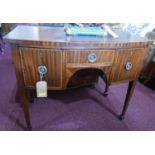 A Georgian inlaid mahogany bow front sideboard of small proportions, with three drawers, raised on