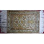 A 20th century fine pure silk Turkish Hereke rug, signed by maker, with vase of flower design, on