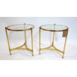 A pair of contemporary gilt occasional tables with circular glass tops