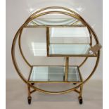 A contemporary Art Deco style drinks trolley, the three tiers with bevelled glass tops, on