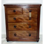 An early 19th century mahogany chest of two short over three long drawers, raised on bun feet, H.111