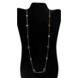 A 14ct yellow gold cabochon sapphire and facated aquamarine long chain necklace composed of 8