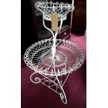 A white painted wire two tiered circular plant stand, on three scrolling feet, H.90cm Diameter 56cm
