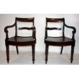 A pair of Regency mahogany scroll armchairs