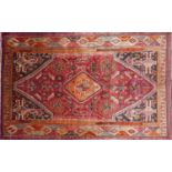 A south west Persian Qashqai carpet the central diamond medallion with repeating petal motifs, on