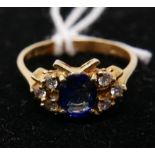 An 18ct yellow gold, Ceylon sapphire (cornflower blue) and diamond ring, the central oval sapphire