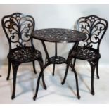 A cast aluminum garden table and two chairs