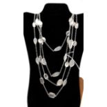 A sterling silver long chain necklace of 2 metres set with 50 oval and pear-drop shaped moonstone