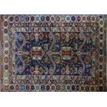 An antique Perpadil rug with two geometric medallions, surrounded by geometric motifs, on a red