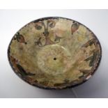 A Middle Eastern earthenware bowl, painted to interior with stylised flowers, H.8cm Diameter 22cm